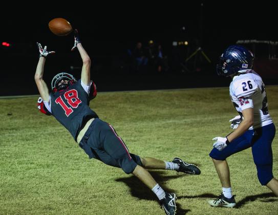 North Rock Creek’s Trey Bray, left, stretches for a tipped pass in the end zone against Metro Christian Thursday night. Metro won, 41-12, to finish the season with a perfect 10-0 record. Playing in a district for the time in NRC’s short history, the Cougars finished the season with a 3-7 overall record and a 2-5 district mark. Photo/Rick Hester