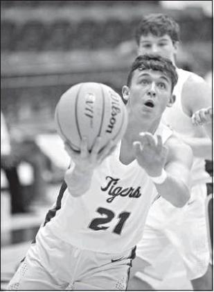 Lower left, Bryce Hughey puts up a shot in the Stroud boys’ first-round loss to Tecumseh.. Photos/Brian Blansett