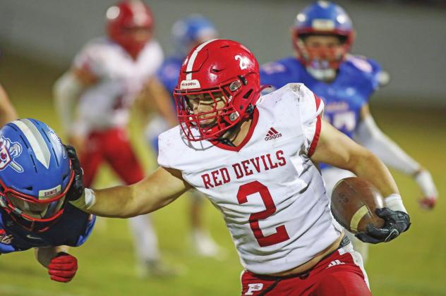 Prague running back Trevor McGinnis puts a stiff-arm on a would-be tackler from Oklahoma Christian. Photo/Rick Hester