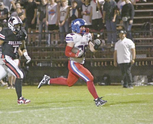 Carson Clagg (26) breaks into the clear on one of his four touchdown runs against Meeker Friday night. Photo/Brian Blansett