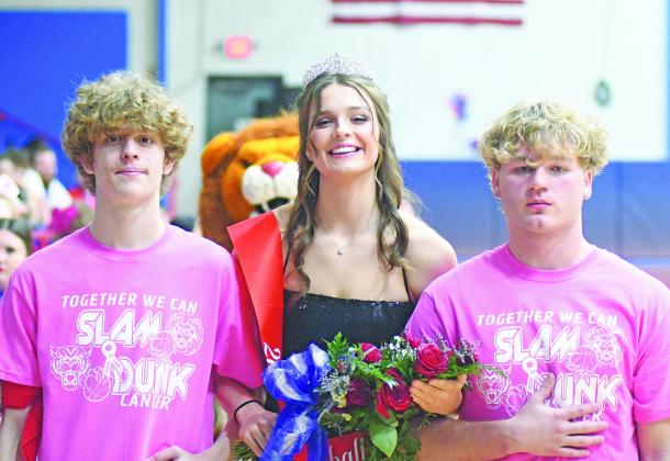 Chandler basketball homecoming queen Mia Callegan poses with escorts Peyton Floyd, left, and Carson Clagg following coronation ceremonies Friday evening.