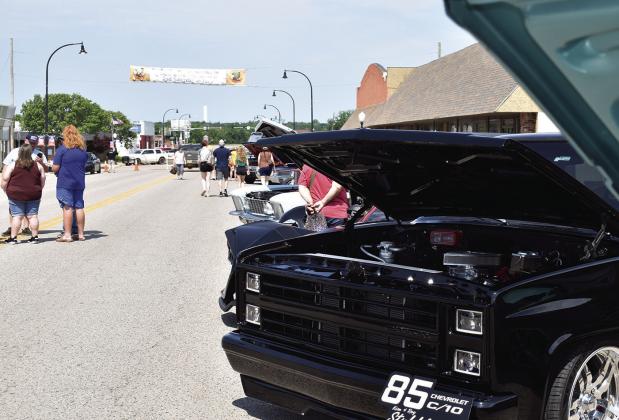 People browse the car show at Stroud SummerFest 2024 on Main Street. Photo/ Emily Kalka