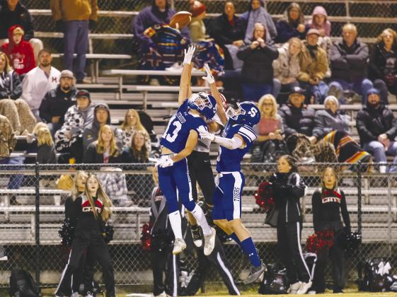 Above, Stroud defenders Aiden Collins (13) and Jeremiah Cropp (5) sandwich a Morrison receiver on a high pass. Stroud gave up only 37 yards passing to Morrison. Below, the Tigers ran onto the field with flags flying in honor of Veterans Day. Photos/Rick Hester