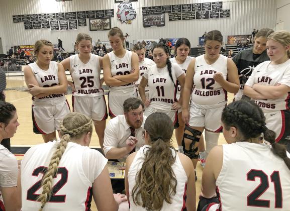 Meeker coach Matt Jones talks to the Lady Bulldogs during a timeout in the closing seconds of their win over Wellston. Photo/Brian Blansett