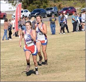 Below middle, Chandler freshman Cassie Wright (1528) and sophomore Leah Brannon kick to the finish line.