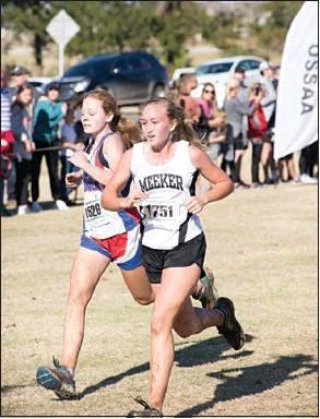 Bottom, Meeker junior Callie Sellers (white singlet) and Chandler sophomore Shayla Peery go neck and neck toward the finish line.