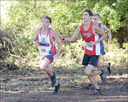 Right, Chandler’s Brayden Danker gets a nudge from Plainview’s Ethan Lollman as they go through a mudhole in the course’s south loop. Lower right, Riley Randall has a mudhole to himself.