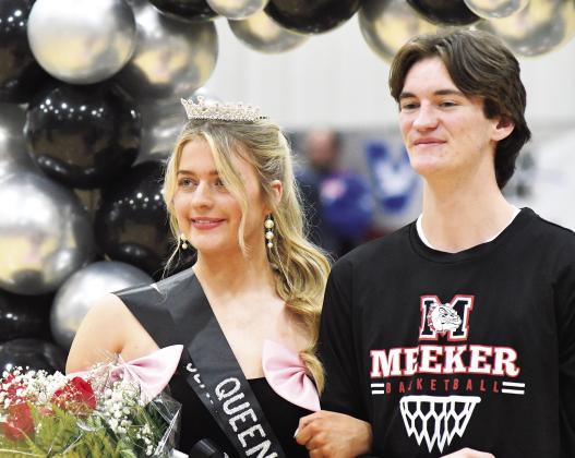 Annsley Babek, posing after coronation with escort Ean Watham, was crowned Meeker Homecoming queen Friday night before the Bulldogs’games with Stroud.