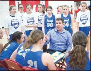 Above, coach Jake Jobe talks to the Lady Tigers during a timeout late in their comeback overtime win against McLoud.
