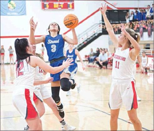Right, Kileigh Mixon (3) puts up a s shot in the land.