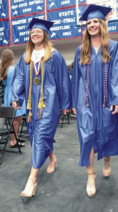 It was graduation and alumni weekend in Chandler Friday and Saturday. Above, the class of 2008 brought the happy and the candy to the annual parade down Manvel Avenue on Saturday morning. After substantial rains, the skies cleared on Saturday and had nearly perfect weather for the parade. Right, Sadie Sherman and Cassie Wright lead the graduating class down the aisle in the gym Friday night. Anticipated rain forced cancellation of plans for the ceremonies to be at Joe Telford Stadium. Photos/Brian Blansett