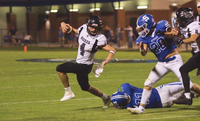 Meeker quarterback Ty Gabbert eludes pressure from the Stroud defense. Photo/Rick Hester