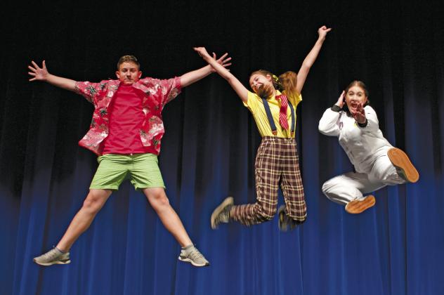 From left, Shaun Birdwell, Kendall Ahrend and Ilsa Arballo leap for joy in the Stroud High School Performing Arts Center. The three high are playing the leads in the school’s production of SpongeBob the Musical -- Patrick, SpongeBob and Sandy Cheeks. Opening night is Nov. 22.