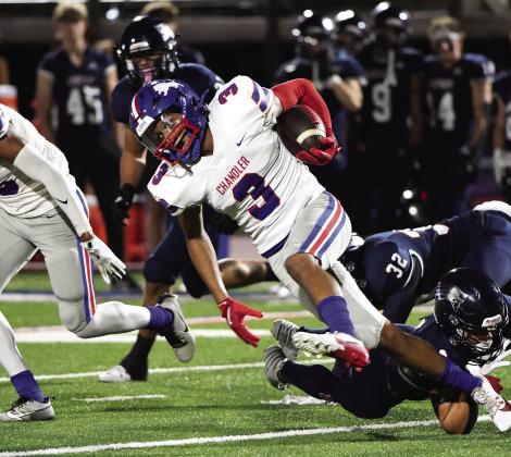 Chandler’s Darius Wade (3) eludes a couple of would-be tacklers from Metro Christian. Photo/Brian Blansett