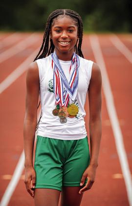 Brooklyn Hammons, with some of her track medals. Photo/Evan Kennemer