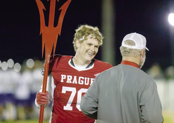 Prague senior Dillon Cooper talks with Coach Rafe Watkins after the Red Devils’ district-clinching win over Vian Friday night. Photo/Rick Hester