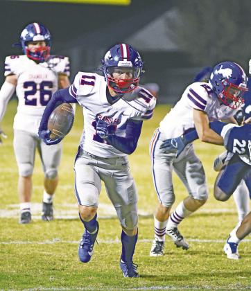 Chandler’s Ty Garver (11) runs through a gap during the Lions’ 23-14 win over Star-Spencer Friday night. The win clinched a home-field berth for the Lions in the first round of the playoffs. Photo/Brian Blansett
