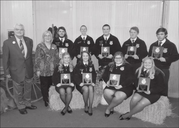 Jamie Barrick and Gordon Richards, Jr., standing far left, of Richards Drug Stores, presented nine FFA students with their awards Monday night during the 75th annual Richards FFA Banquet. Recipients of the award sitting from left to right are Jesse Moore, Macomb, Terah Garcia, Asher, Dassie May, Shawnee and Maycee Spain, McLoud. Standing left to right are Konnor McKey, North Rock Creek, Colton Ingmire, Bethel, Jacob Nunley, Tecumseh, Shane Rodman, Wanette and Paden Thomas, Dale. Photo/ Jennifer Pitts