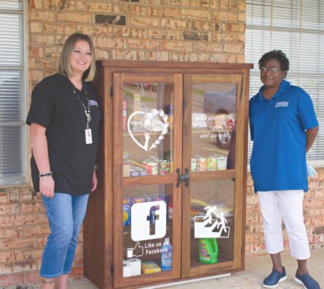 Receptionist Nancy Townsend and Program Manager Obzynder Robinson stand by the food pantry outside the Dorthy M. Smith Family Medical Center. Photo/Chelsea Weeks.