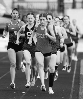Prague’s Hailey Johnson leads the pack at the Bristow track meet. Jordyn Neeley from Stroud is on her right shoulder. Photo/Beth Young
