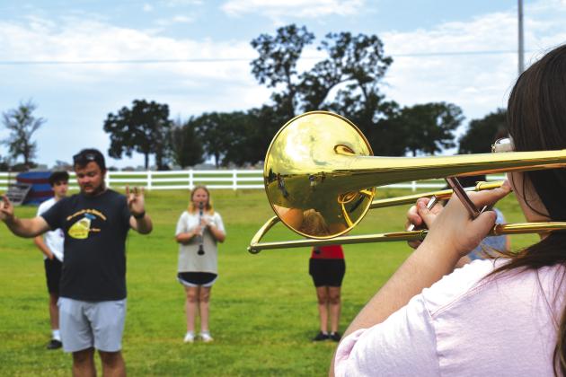 Chandler Band Director Zachary Fisher directs members of the Pride of Chandler marching band through warm-ups at band camp on July 31. Photo/Emily Kalka