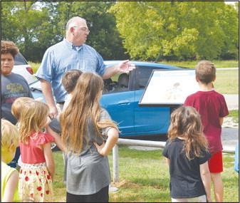 Chandler Mayor Kent McVey reads a story panel to a group of children last week. Photo/Emily Kalka