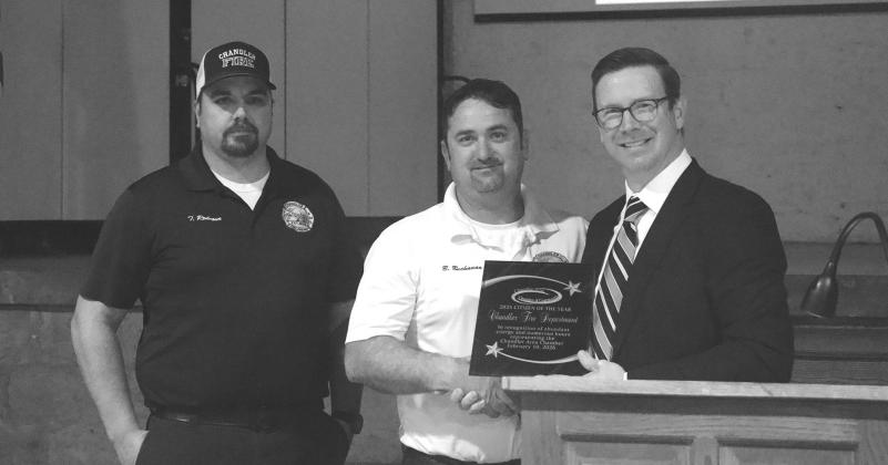 Chandler Fire Chief Bobby Buchanan (center) and Assit. Chief Tony Rednour (left) accept the Citizen of the Year Award from Chandler Area Chamber of Commerce President Brian Bendele at the group’s annual banquet on Feb. 10 at the Route 66 Interpretive Center. Photo/Emily Kalka