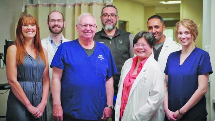 Orville Fisher (center left in the front) stands with the Stroke Team at SSM Health St. Anthony Hospital. For years, Fisher has worked to help improve stroke care at the hospital. Photo/SSM Health