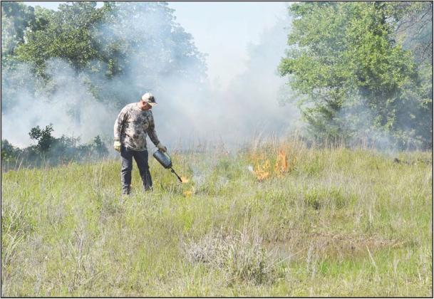 Todd Moehlenbrock sets a portion of his property on fire during a prescribed bum on May 4 done through Cross Timbers Prescribed Bum Association. Photo/Emily Kalka