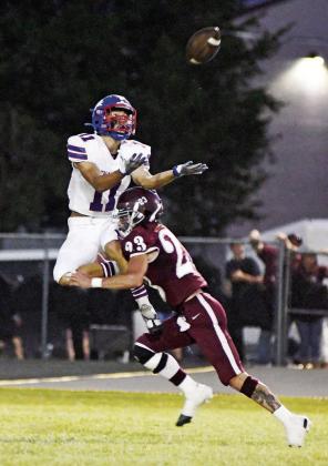 Above, Chandler’s Ty Garver (11) keeps his eye on the ball and plays through contact by Kellyville’s Nathan Stubblefield (23) during the second quarter Friday night. Garver appeared to come down with the ball, but the pass was called incomplete with no interference. Below, Casmen Hill looks upfield after leaving a would-be tackler in his wake. Photos/Brian Blansett
