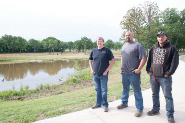 Above: walkers take advantage of the concrete paths. Below: left to right, Cody Roe, Nick Morales and Robert Spurlock. Photos/Brian Blansett