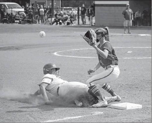 Left, Emma Davis slides into third in the Stroud Lady Tigers’ game against Dale. Photo/Rick Hester