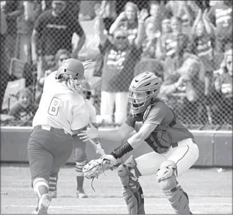 Right, Prague runner Adisyn Auld eludes a proposed tag by the Sulphur catcher and scores a run in the state tournament. Photo/Brian Blansett