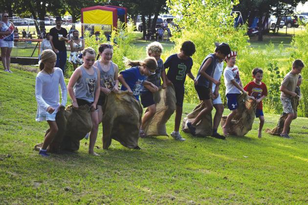 contestants push their way through the hot dog eating contest in Davenport. They were given five hot dogs to eat in three minutes and the one who ate the most won. Photo/Emily Kalka