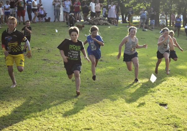 Kids kicked the tires and lit the fires as they raced for the finish line during the foot race at Davenport on Friday. Photo/Emily Kalka