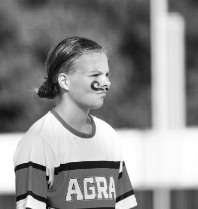 Prague shortstop Ainsley Auld looks to the ump for confirmation after forcing a Henryetta runner at second base on Tuesday. Below, Agra third baseman Julia Olson sports a retro ‘stache during the Lady Bearcats game against Davenport. Photos/Brian Blansett