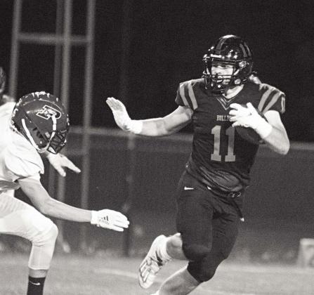 Davenport’s Parker Mitchell (11) drops a Heisman move on a Prue defender during the Bulldogs’ 56-6 victory. Photo/Chelsea Weeks