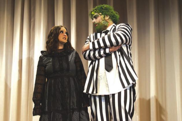Avree Haney, who plays Lydia Deetz, stands next to Eli Ford, who plays Beetlejuice, during dress rehearsal of McLoud High School’s production of “Beetlejuice Jr” on April 26. Photo/Emily Kalka