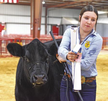 Devyn Frazier from Meeker accepts the awards for her breed champion Maintainer at the Lincoln County Livestock Show last week. For more photos from the how, please see Page 1D and for results listings, please see Page 3D. Photo/Emily Kalka
