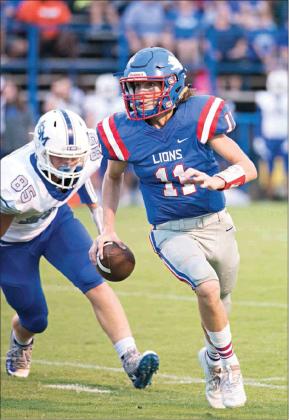 Quarterback Kaden Jones (11) eludes a would-be tackler en route to the game’s first touchdown against Mount St. Mary. Photo/Brian Blansett