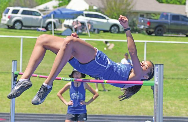 Above, defending state champion Kileigh Mixon keeps her eyes on the bar as she clears 5-6 in the high hump Saturday at the Stroud regional. Below, pole vaulter Drew Clovis from Stroud easily clears his bar. See Page 3C for more photos. Photos/Brian Blansett