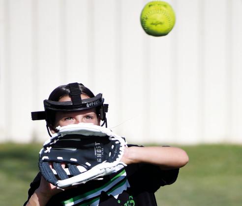 A field full of girls showed up for the annual Chandler softball camp last week. Above, Dani Weber participates in a fielding drill. The campers also worked on fielding (left) and took part in a spirited bunting game (below left). Photos/Brian Blansett