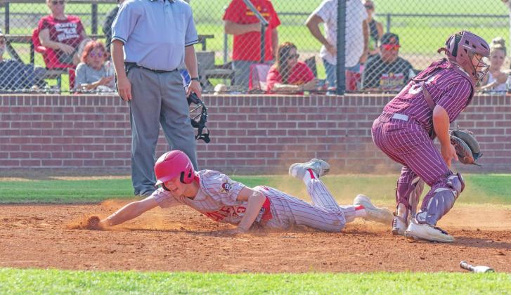 Dason Sheppard slides safely into home for a Dale run. The third-ranked Pirates play Thursday in the state tournament. Photo/Rick Hester