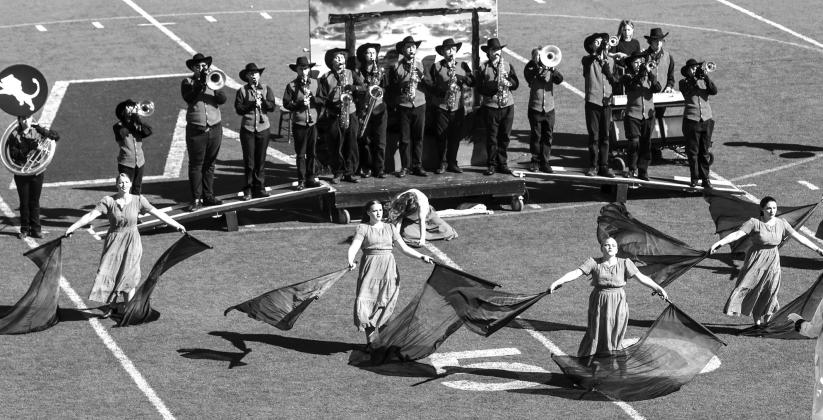 The color guard twirl during the prelim performance. From left to right, Alison Radcliffe, Royanna Berry, Carly Carouthers and Izzy Simpson. Photo/Emily Kalka