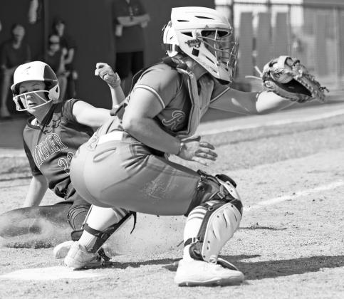 Above, Prague’sAinsleyAuld drops a tag on a Tishomingo runner during regional play on Friday. Below, Chandler’s Blaklei Smith slides in to home plate against Roland in Thursday action. Photos/Brian Blansett
