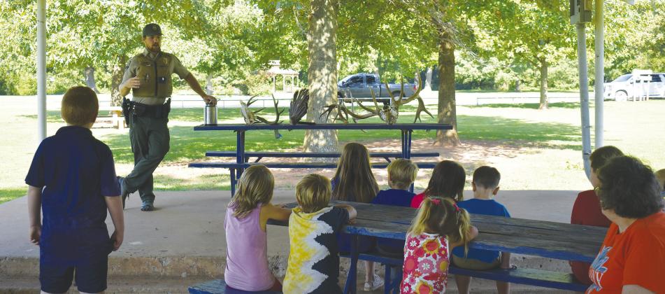 Game Warden Jacob Harriet speaks at a library event in Tilghman Park. Photo/Emily Kalka