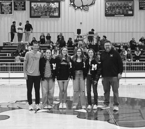 Meeker presented its academic letter jackets last week. Pictured above, left, are boys recipients Derrick Shouse, Keagan Edmonds, Gage Danielewicz and Aiden Hessman with Principal Brad Buxton. Above right are Kara Casteel, Brooklyn Lynch, Kylie Way and Mariah McDoulett with Mr. Buxton. Photos/Robyn Miller.