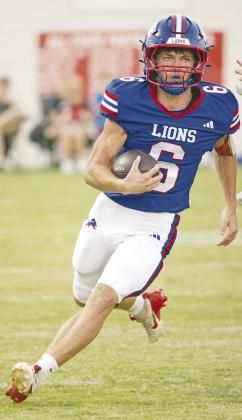 Chandler quarterback Chace Buchanan looks upfield during a long run in the first quarter. Photo/Brian Blansett