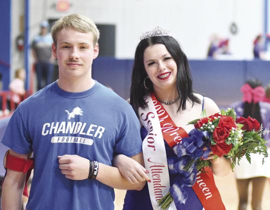 Chandler’s wrestling homecoming queen Adalyn Massie pauses with escort Stran Messer after her coronation last week. Photo/Brian Blansett