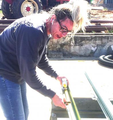 Left, Megan Ballard cuts metal to be used for repair on the McLoud Historical Society Museum and Heritage Center.